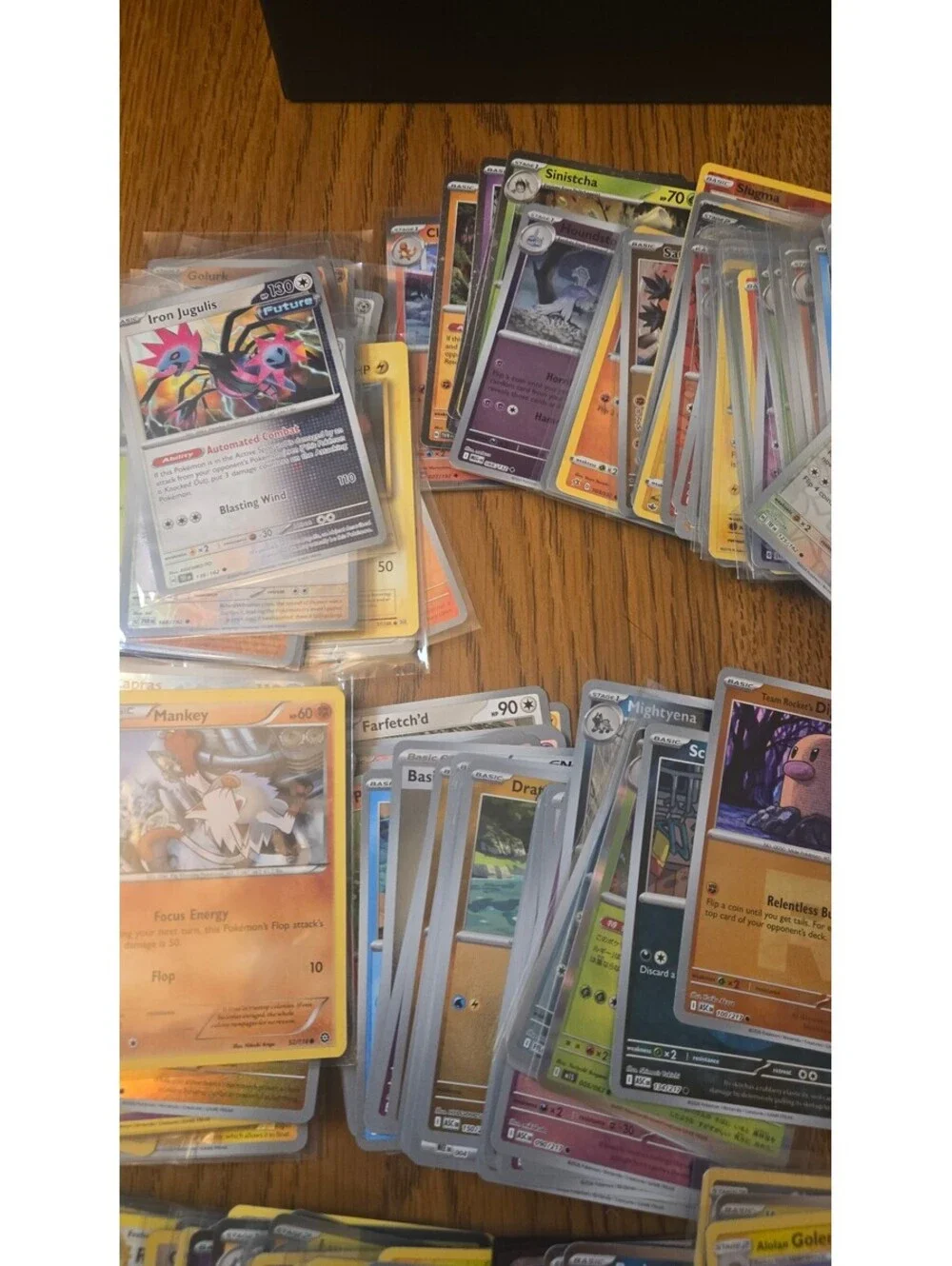 Bulk Lot of Mixed Pokemon Trading Cards with Sleeves and Storage Box